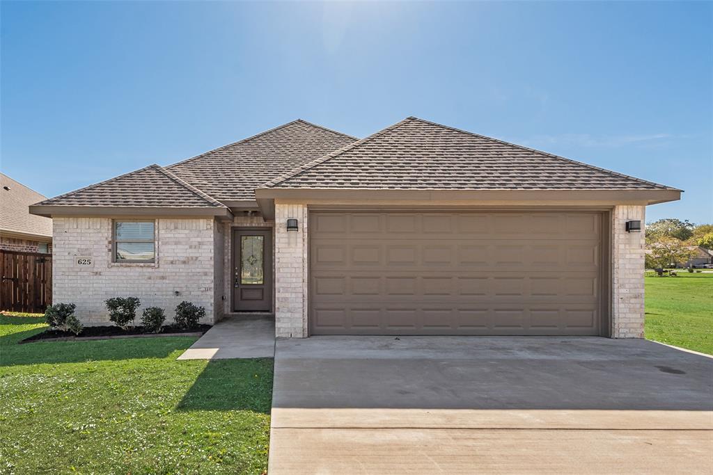 625 Copenhavr Street Pilot Point, TX 76258 - Photo 2 of 20 View of front facade featuring brick siding, a front yard, driveway, a shingled roof, and a garage