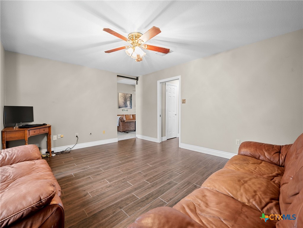 782 Santa Clara Loop Marion, TX 78124 - Photo 32 of 48 a living room with a bed furniture and a flat screen tv