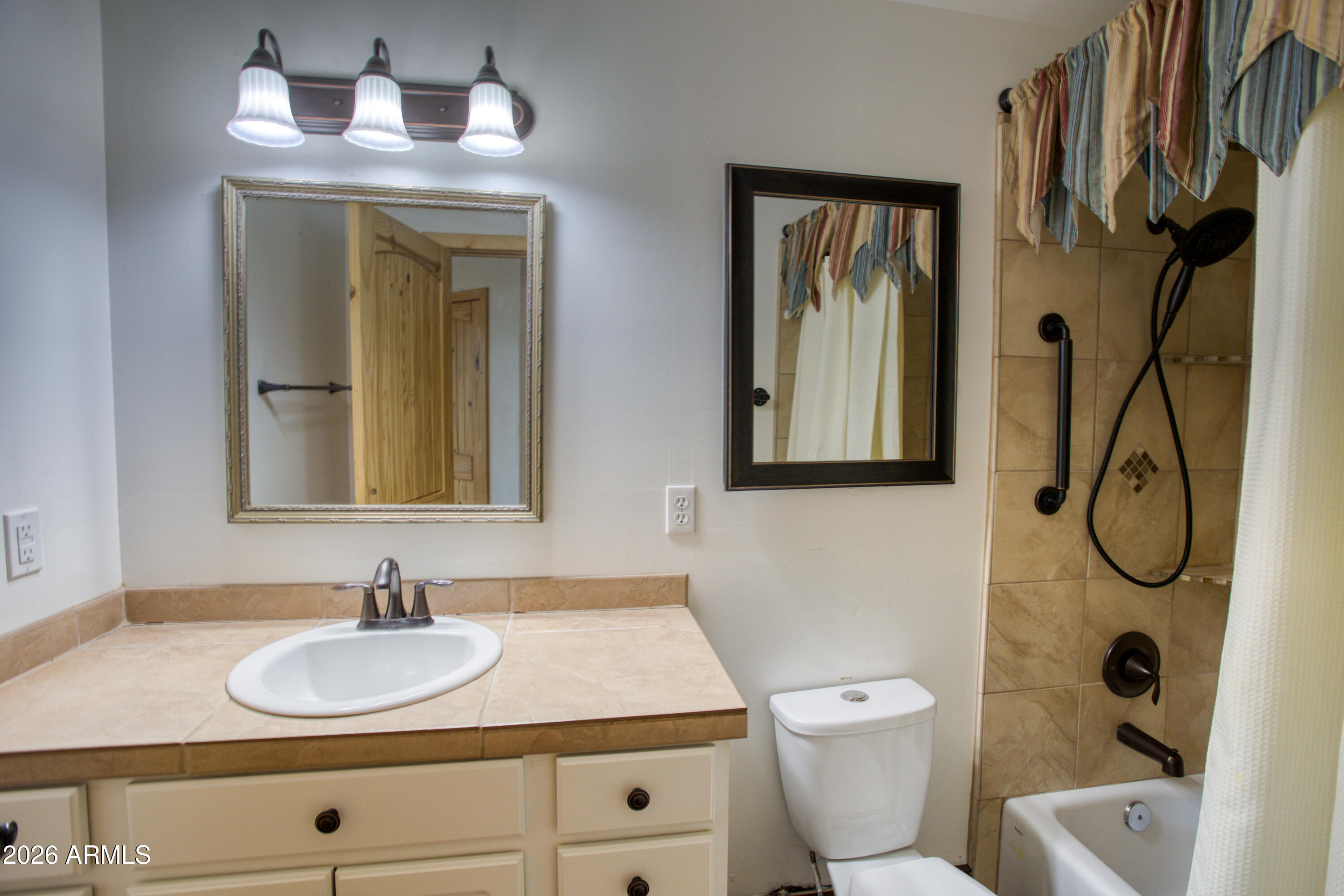 1420 Meadow View Place Show Low, AZ 85901 - Photo 11 of 25 a bathroom with a toilet sink and mirror