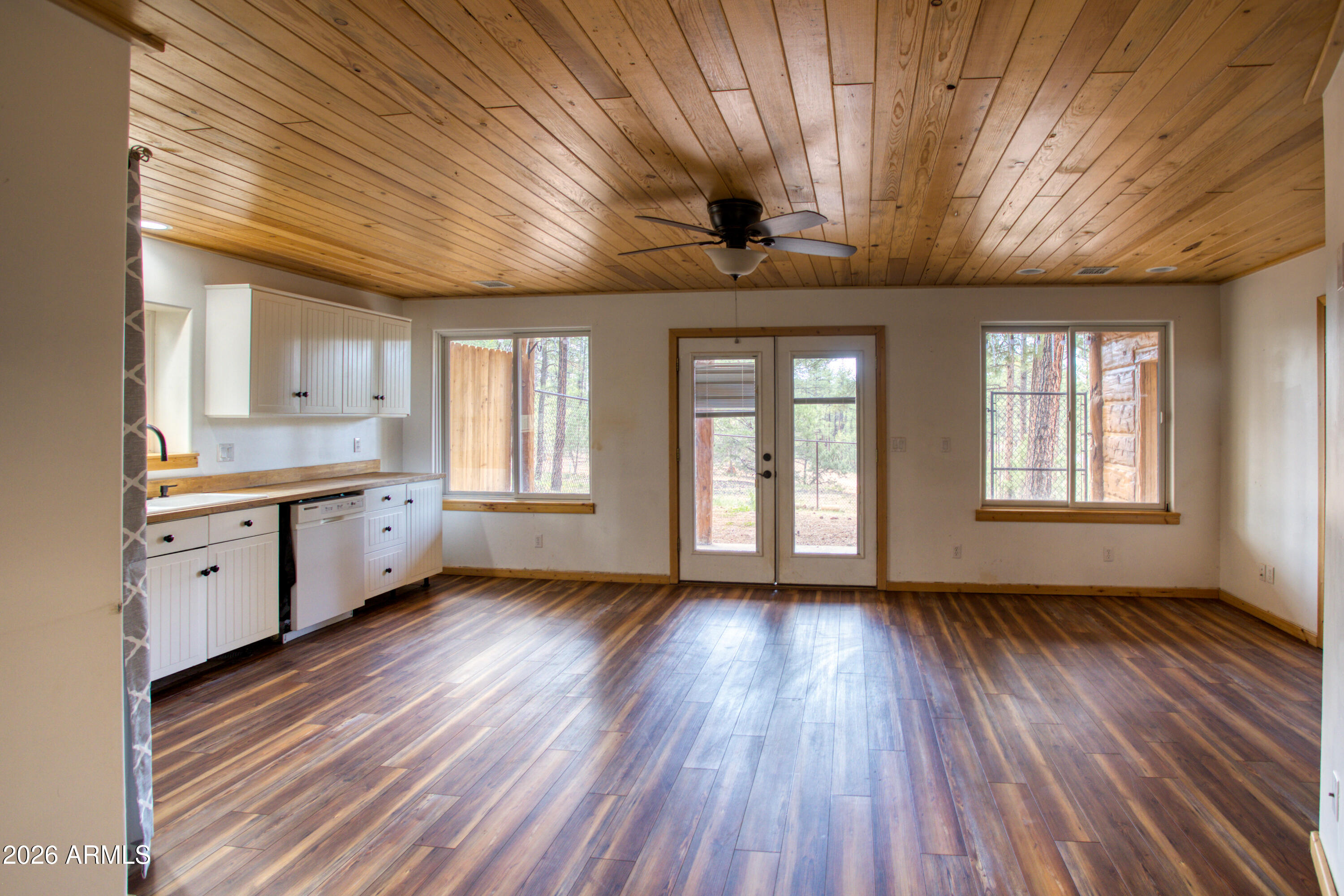 1420 Meadow View Place Show Low, AZ 85901 - Photo 18 of 25 a view of an empty room with a window and wooden floor