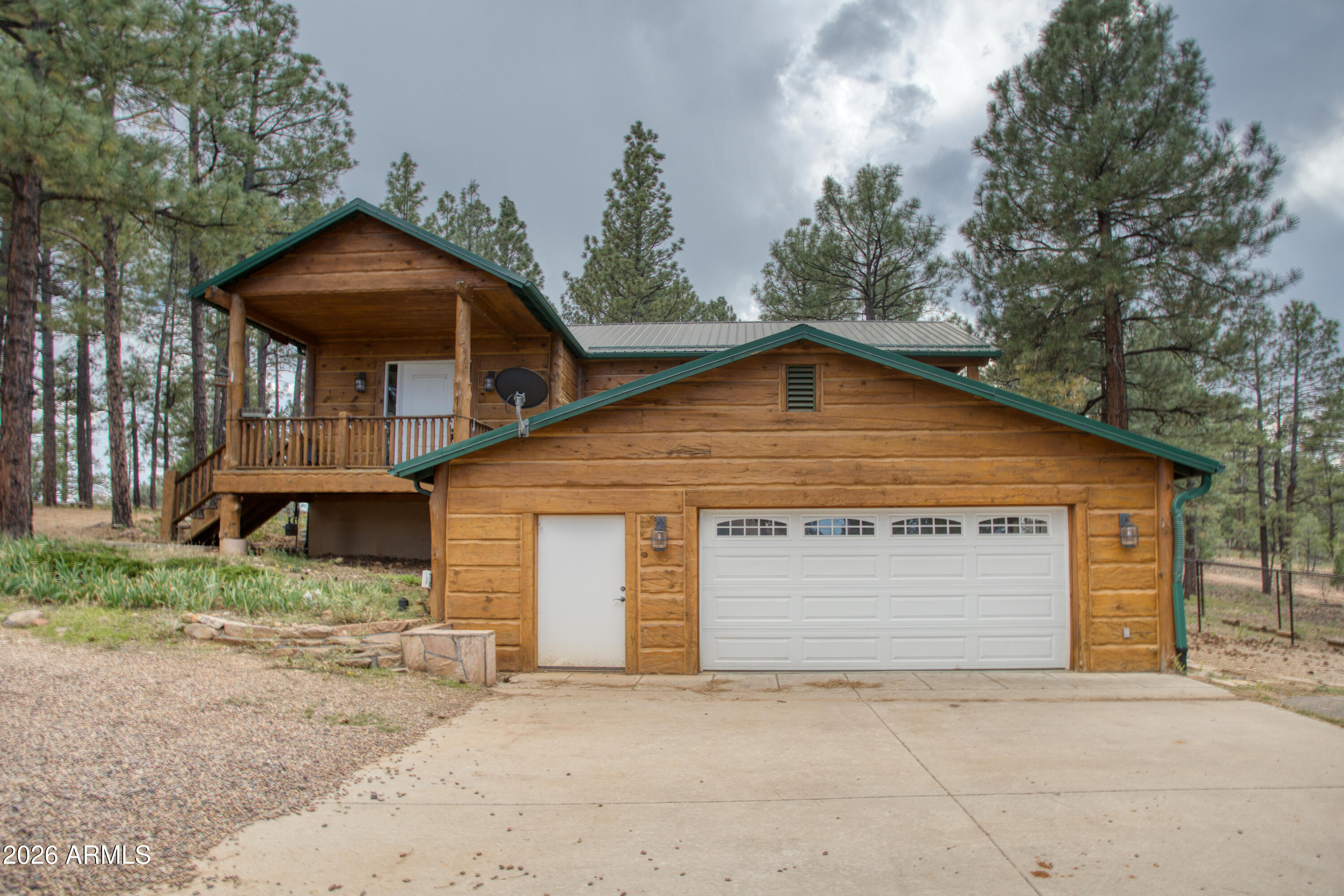 1420 Meadow View Place Show Low, AZ 85901 - Photo 2 of 25 a front view of a house with a garden and trees