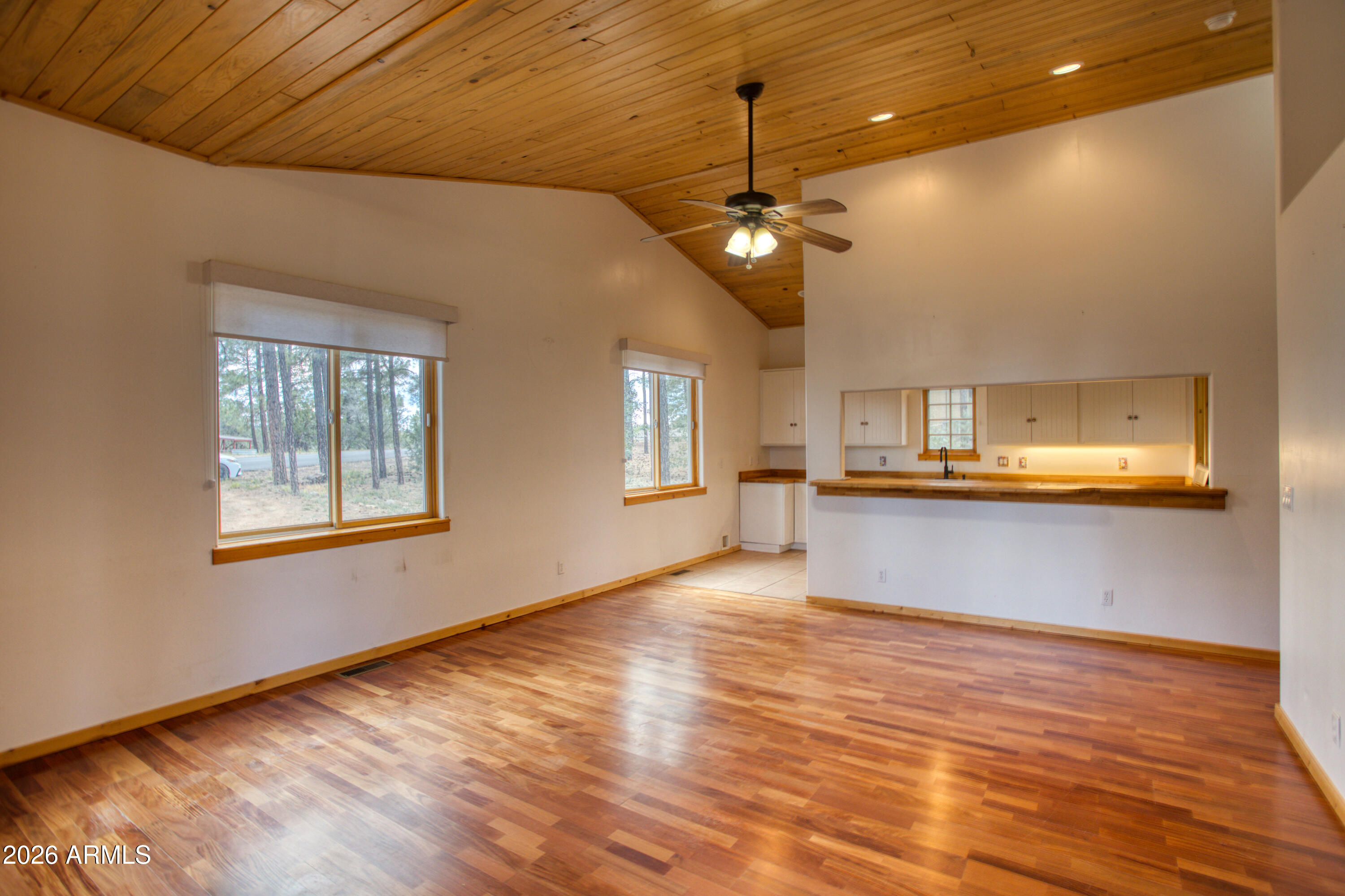 1420 Meadow View Place Show Low, AZ 85901 - Photo 4 of 25 a view of an empty room with window and wooden floor