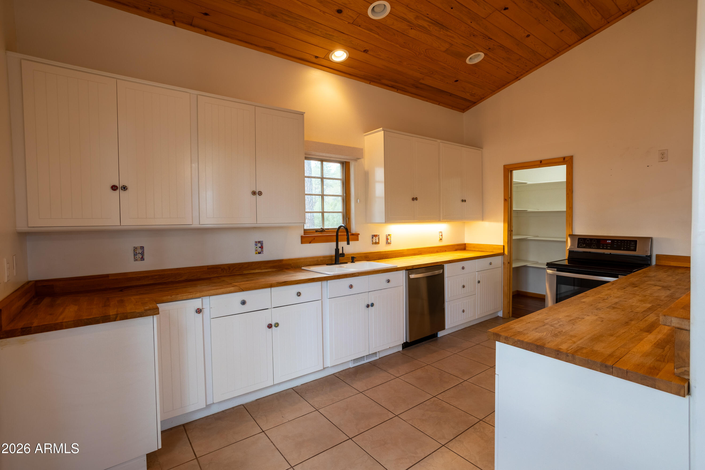 1420 Meadow View Place Show Low, AZ 85901 - Photo 6 of 25 a large kitchen with granite countertop a sink and white cabinets
