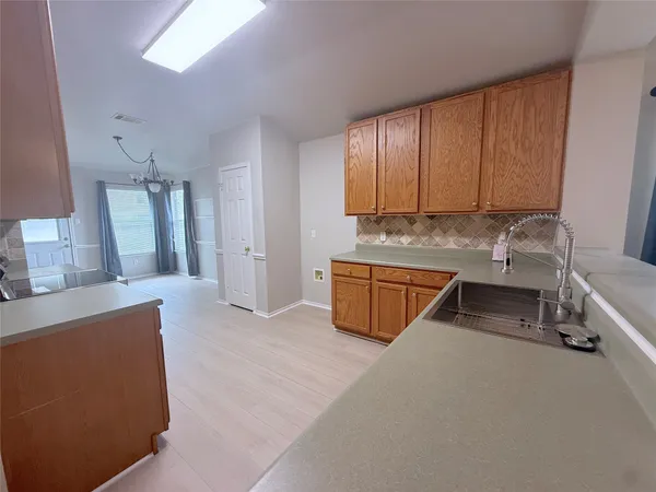 a room with a couch and a view of kitchen