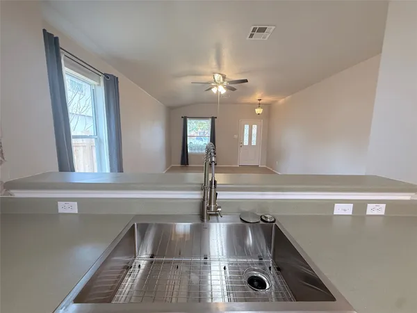 a kitchen with a sink and chandelier