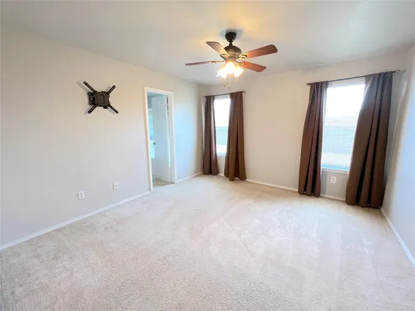 a view of a livingroom with a ceiling fan and window