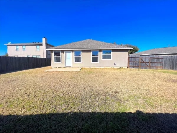 a view of an house with a wooden fence