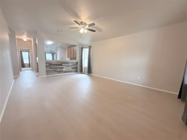 a view of a livingroom with furniture and chandelier fan
