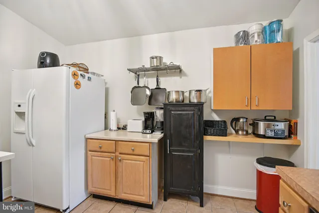 a kitchen with stainless steel appliances granite countertop a stove top oven a sink dishwasher a dining table and chairs with wooden floor