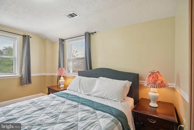 a bedroom with a bed and a table