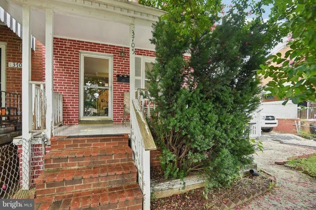 a front view of a house with plants
