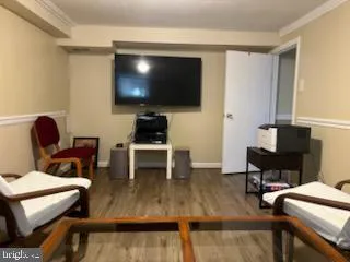 a living room with furniture a flat screen tv and a lamp