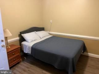 a bedroom with a bed and a view of cupboard