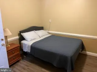 a bedroom with a bed and a view of cupboard