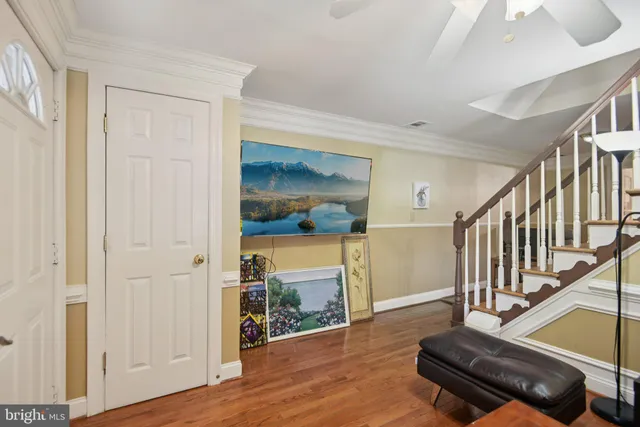 a view of a livingroom with wooden floor and furniture