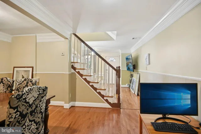 a view of entryway and hall with wooden floor