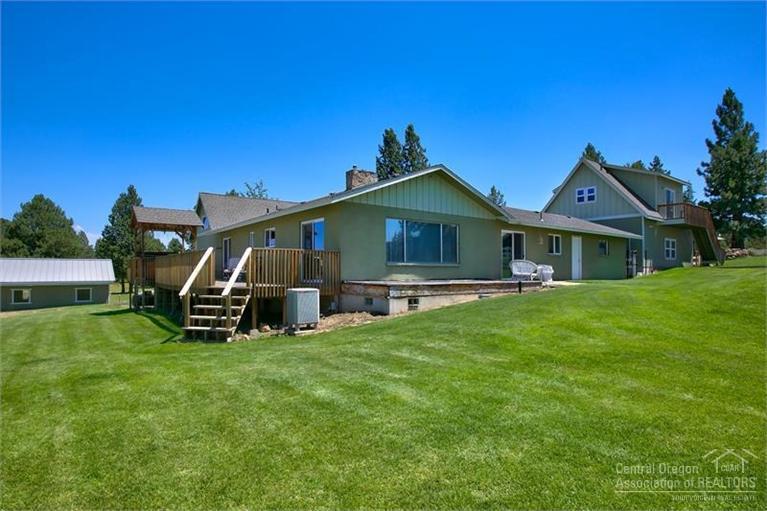 60366 Arnold Market Road Bend, OR 97702 - Photo 7 of 25 a view of a house with a yard and sitting area