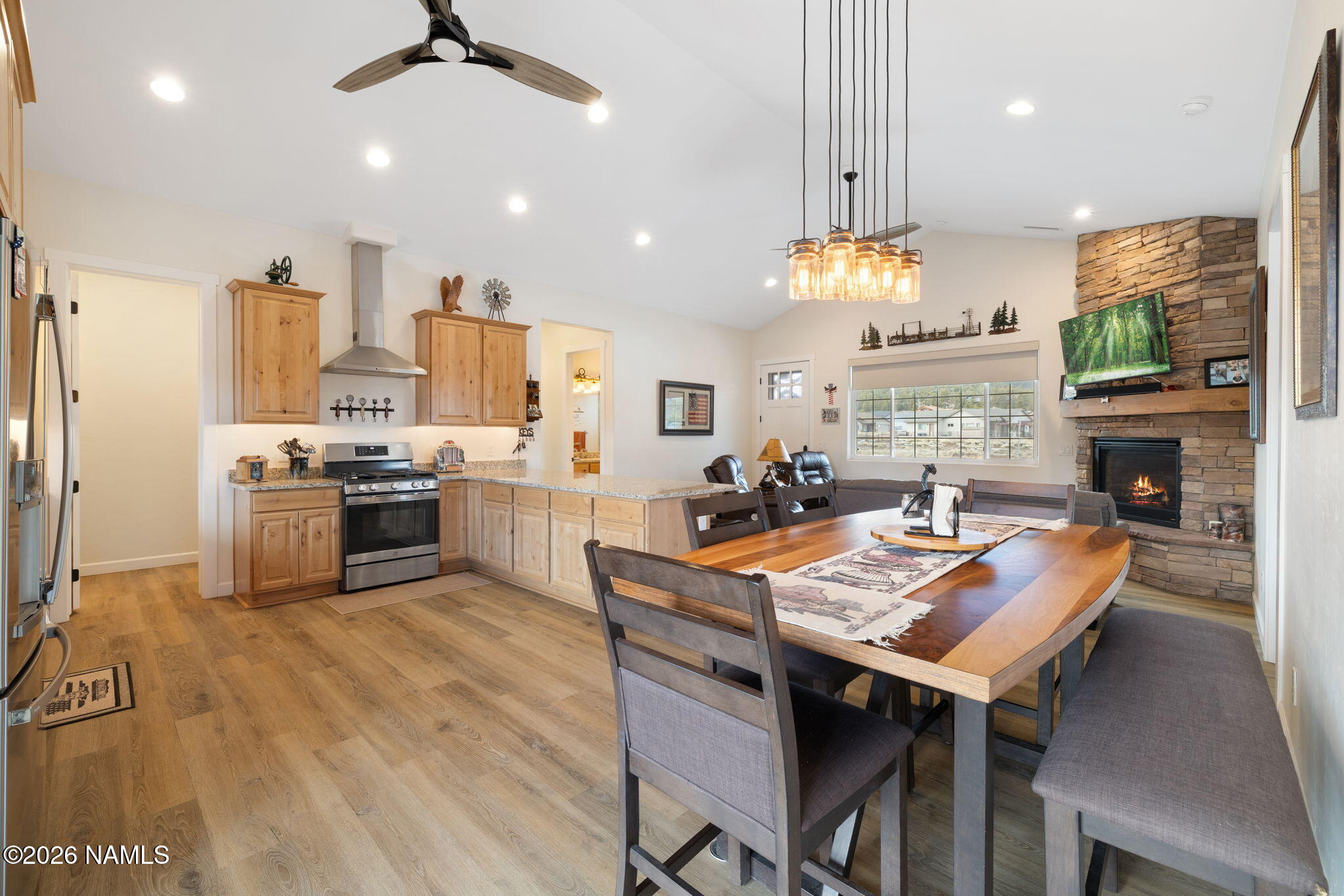 2557 Lazy E Road Williams, AZ 86046 - Photo 13 of 51 a kitchen with stainless steel appliances a dining table chairs stove refrigerator and kitchen view