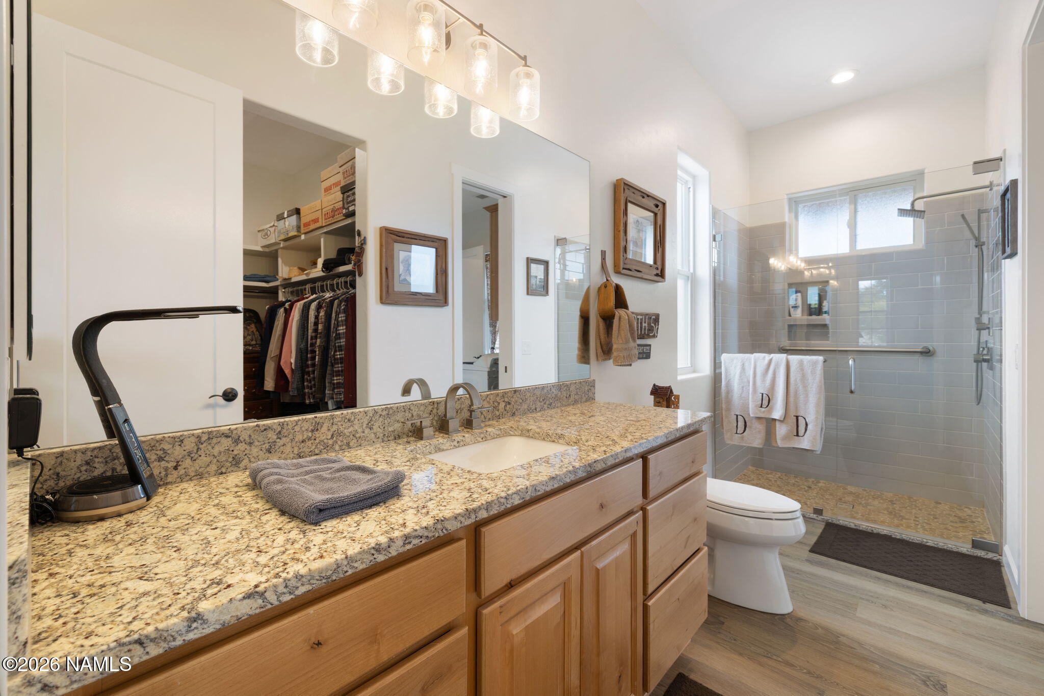 2557 Lazy E Road Williams, AZ 86046 - Photo 18 of 51 a bathroom with a granite countertop sink a toilet and a shower