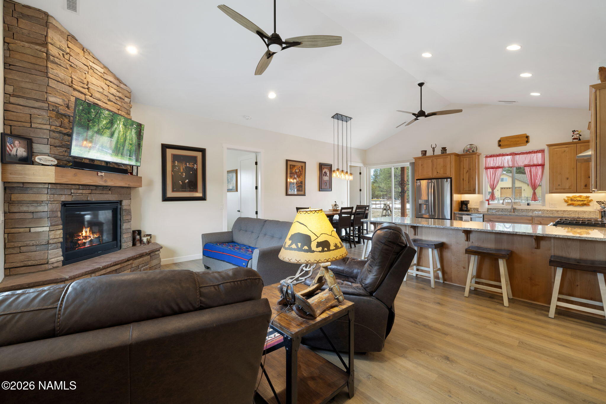 2557 Lazy E Road Williams, AZ 86046 - Photo 4 of 51 a living room with furniture a fireplace and a flat screen tv