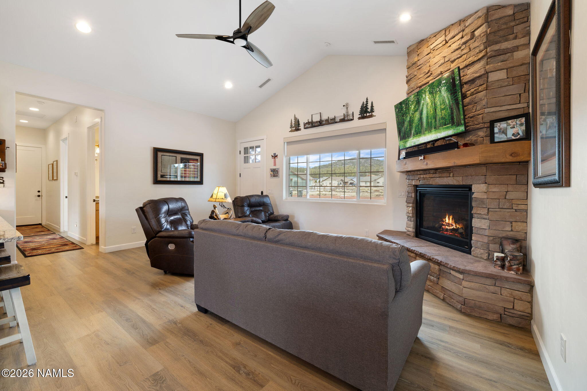 2557 Lazy E Road Williams, AZ 86046 - Photo 6 of 51 a living room with furniture a fireplace and a flat screen tv