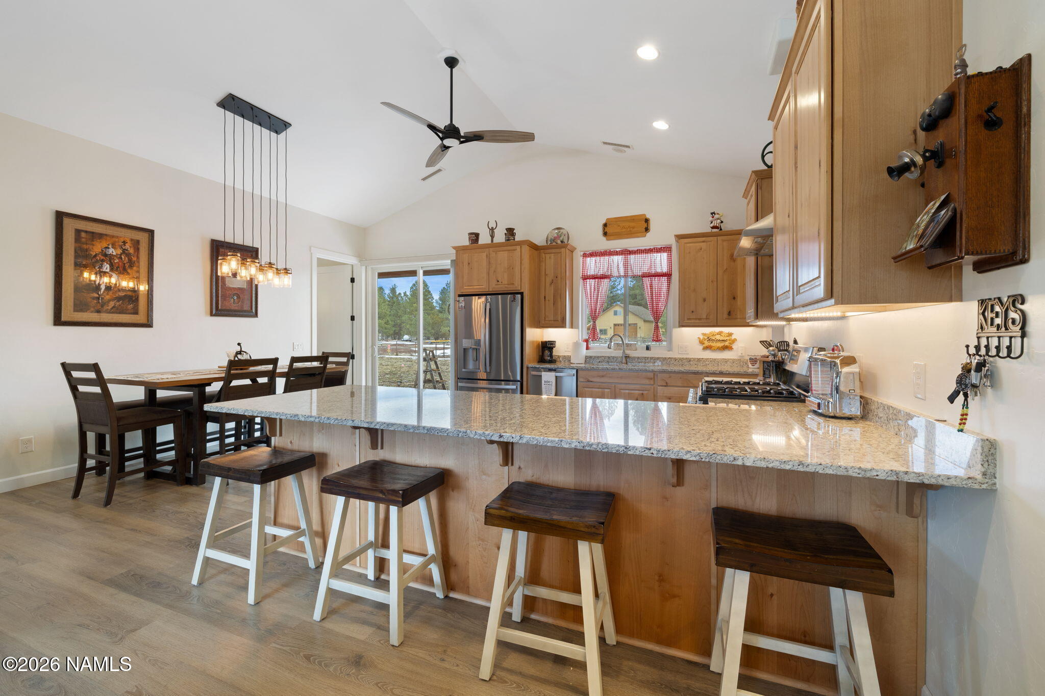 2557 Lazy E Road Williams, AZ 86046 - Photo 8 of 51 a kitchen with a dining table chairs and white cabinets
