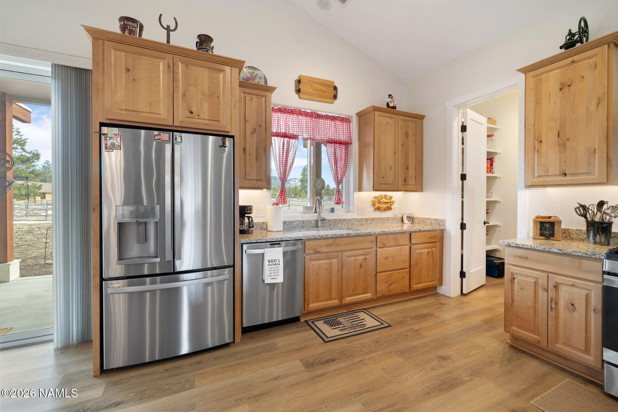 2557 Lazy E Road Williams, AZ 86046 - Photo 10 of 51 a kitchen with stainless steel appliances a refrigerator sink and cabinets