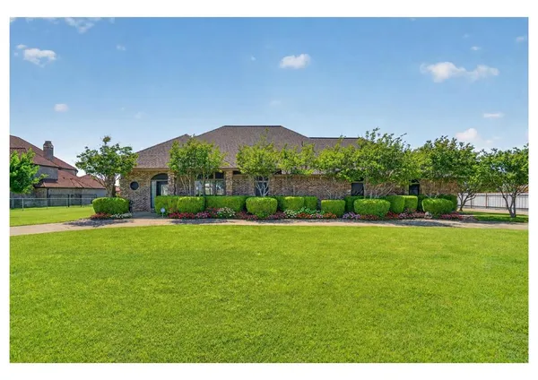 a view of a garden with a building in the background