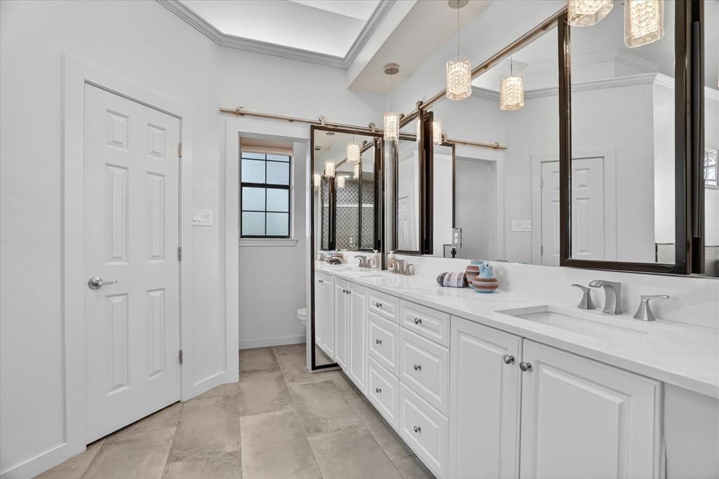 1408 West Cleburne Road Crowley, TX 76036 - Photo 20 of 40 a bathroom with double sink and a mirror