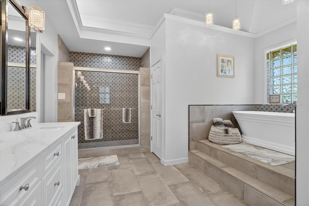 1408 West Cleburne Road Crowley, TX 76036 - Photo 21 of 40 a spacious bathroom with a double vanity sink a mirror and next to a window