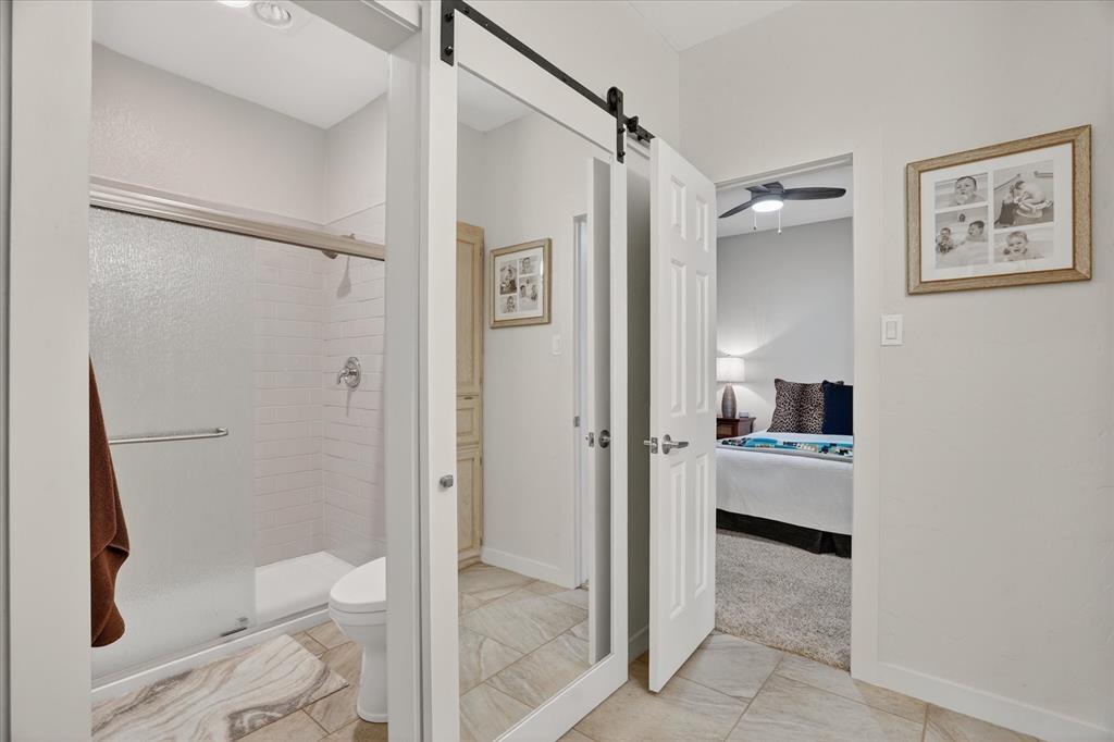 1408 West Cleburne Road Crowley, TX 76036 - Photo 25 of 40 a bathroom with a tub and a glass door shower