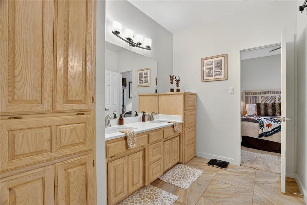 1408 West Cleburne Road Crowley, TX 76036 - Photo 26 of 40 a room with a sink and cabinets