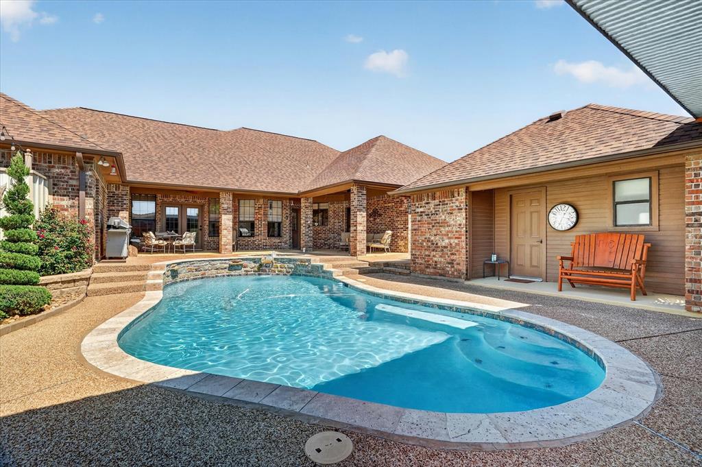 1408 West Cleburne Road Crowley, TX 76036 - Photo 30 of 40 a view of a house with pool fire pit and chairs in patio