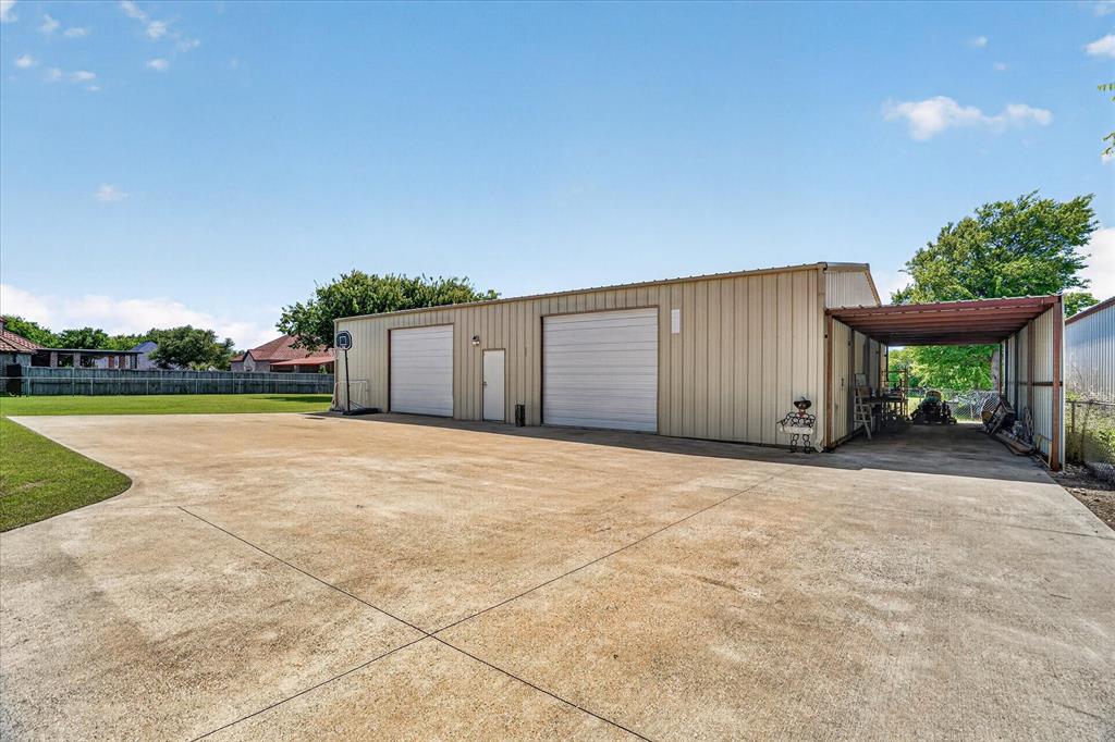 1408 West Cleburne Road Crowley, TX 76036 - Photo 5 of 40 a view of a house with a yard and garage