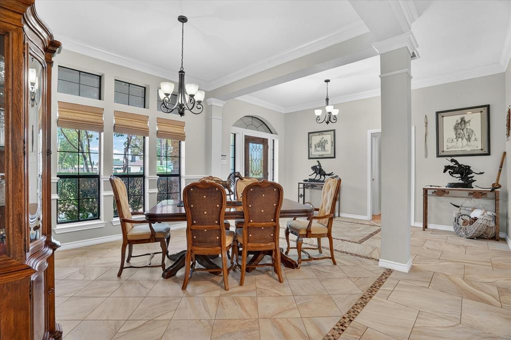 1408 West Cleburne Road Crowley, TX 76036 - Photo 10 of 40 a dining room with furniture a chandelier and window