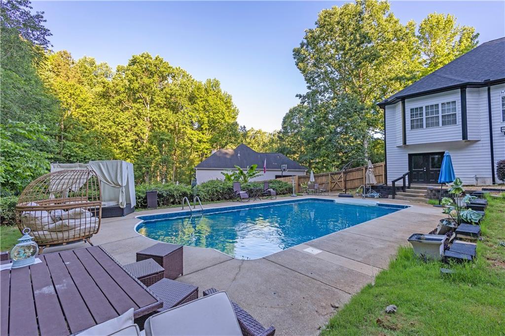 151 Dumar Lane Hoschton, GA 30548 - Photo 6 of 10 a view of a swimming pool with a patio