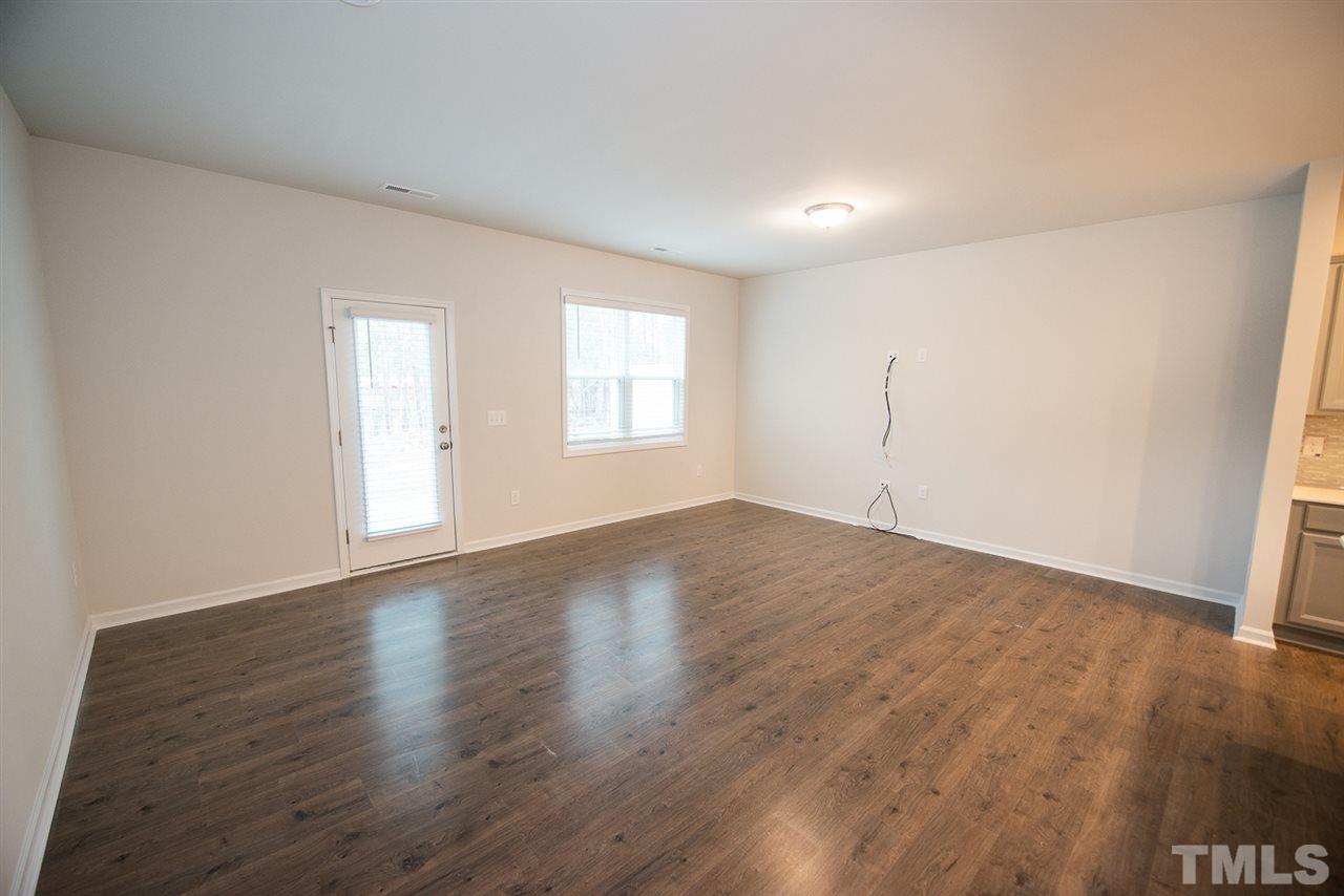 3631 Water Mist Lane, Unit 16 Raleigh, NC 27604 - Photo 3 of 28 an empty room with wooden floor and windows