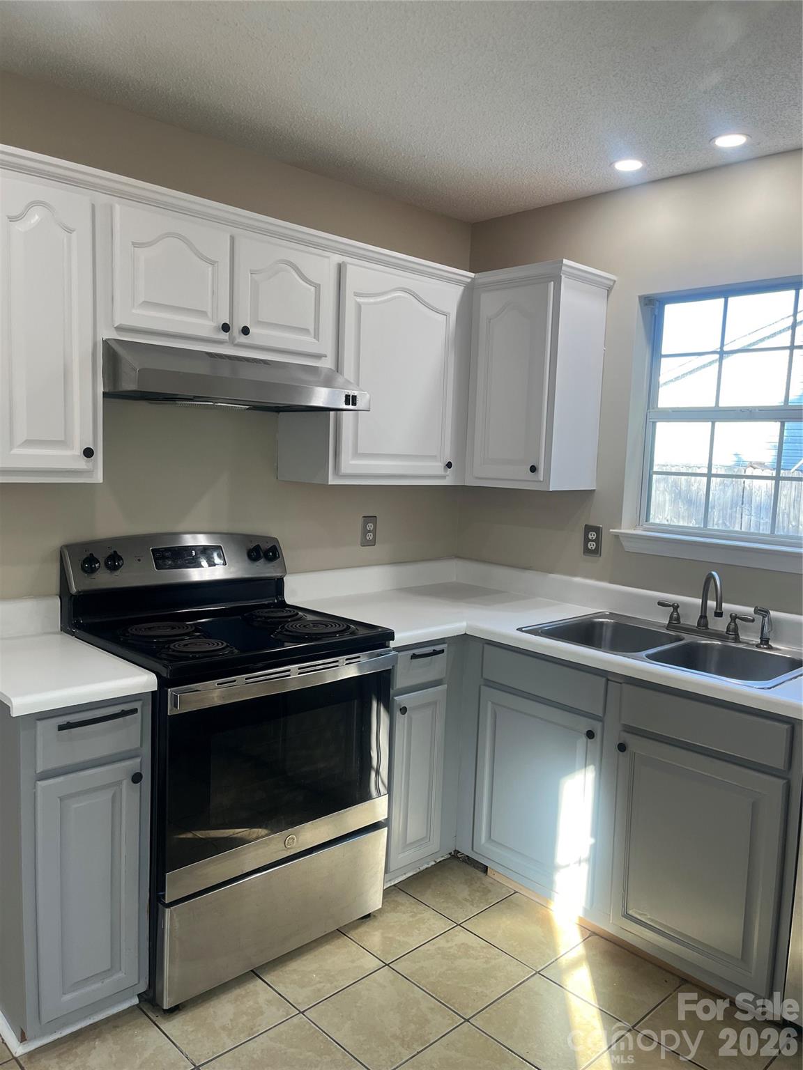314 Tylers Way Fort Mill, SC 29715 - Photo 10 of 16 a kitchen with a stove and white cabinets
