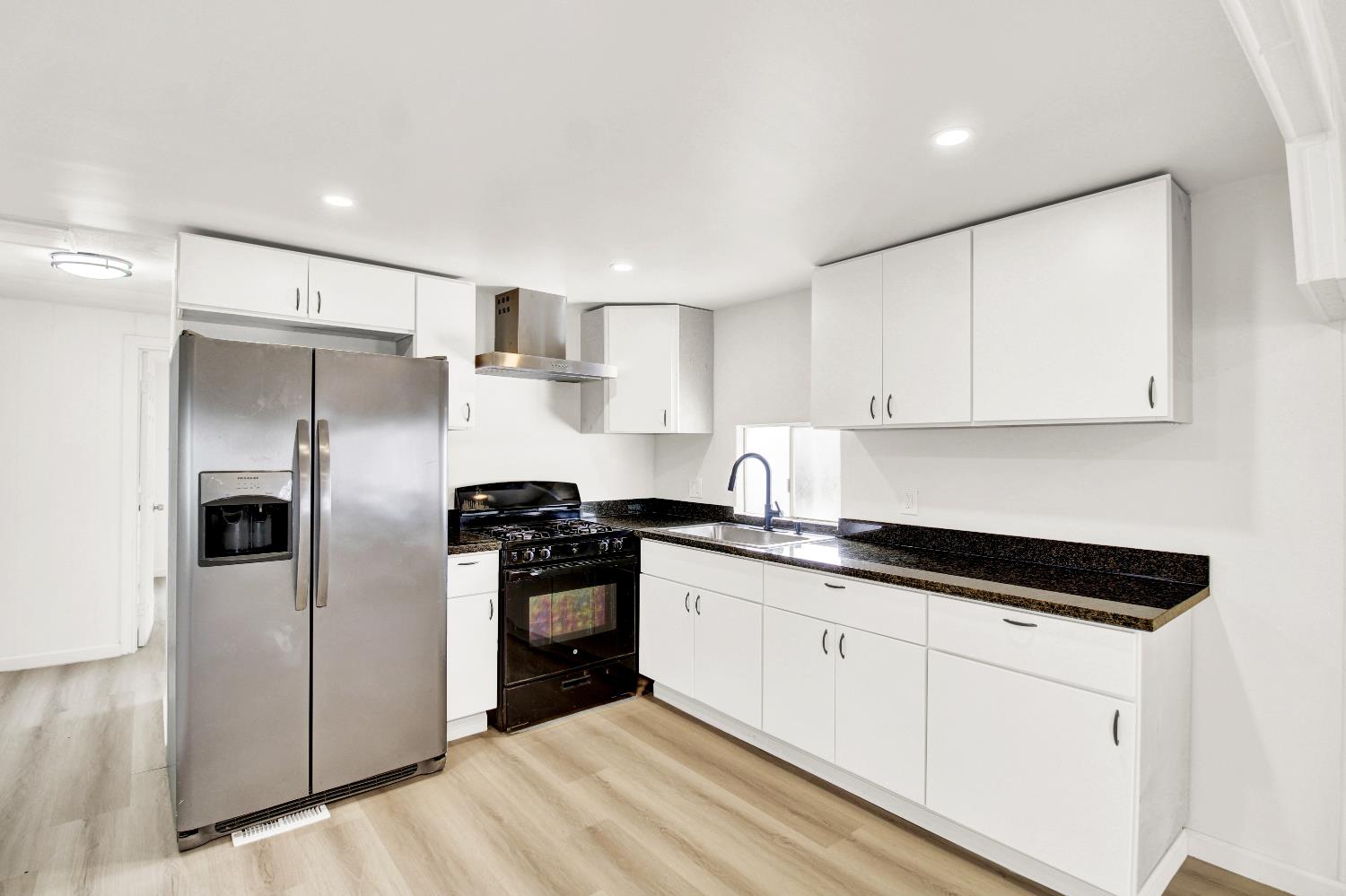 4143 Yosemite, Unit C21 Modesto, CA 95357 - Photo 2 of 25 a kitchen with stainless steel appliances granite countertop a stove a refrigerator and a sink