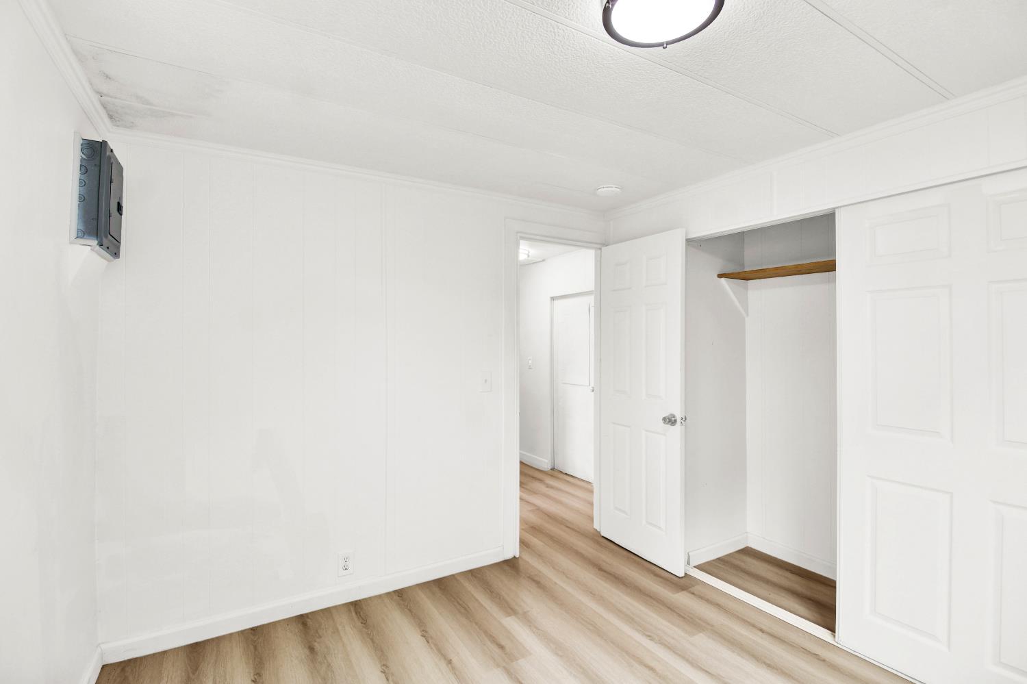 4143 Yosemite, Unit C21 Modesto, CA 95357 - Photo 25 of 25 a view of a room with wooden floor and white walls