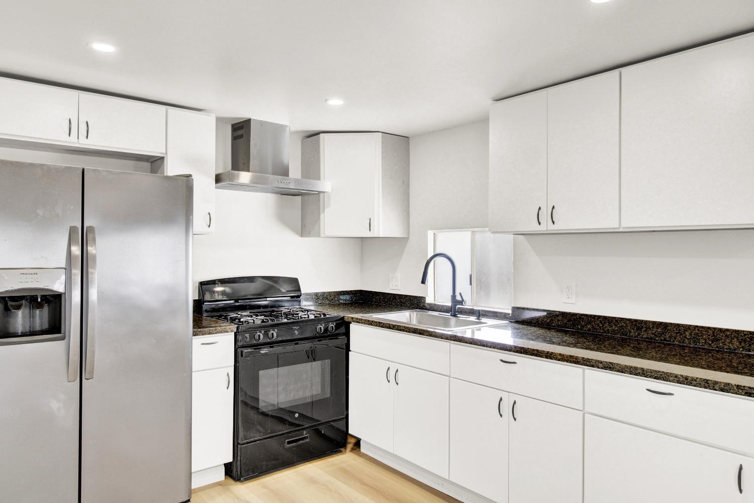 4143 Yosemite, Unit C21 Modesto, CA 95357 - Photo 8 of 25 a kitchen with a sink appliances and cabinets