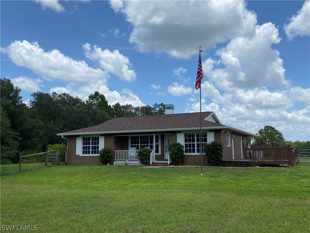 3501 Packinghouse Road Alva, FL 33920 - Photo 1 of 18 a front view of a house with a garden