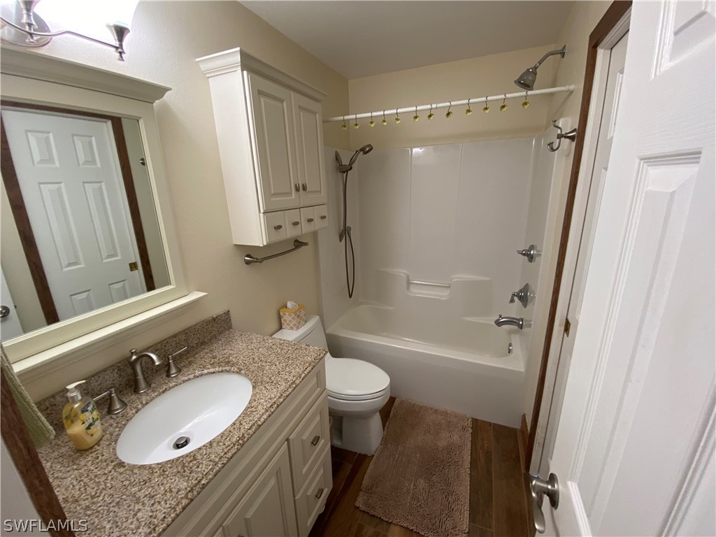 3501 Packinghouse Road Alva, FL 33920 - Photo 11 of 18 a bathroom with a granite countertop sink toilet mirror vanity and a shower