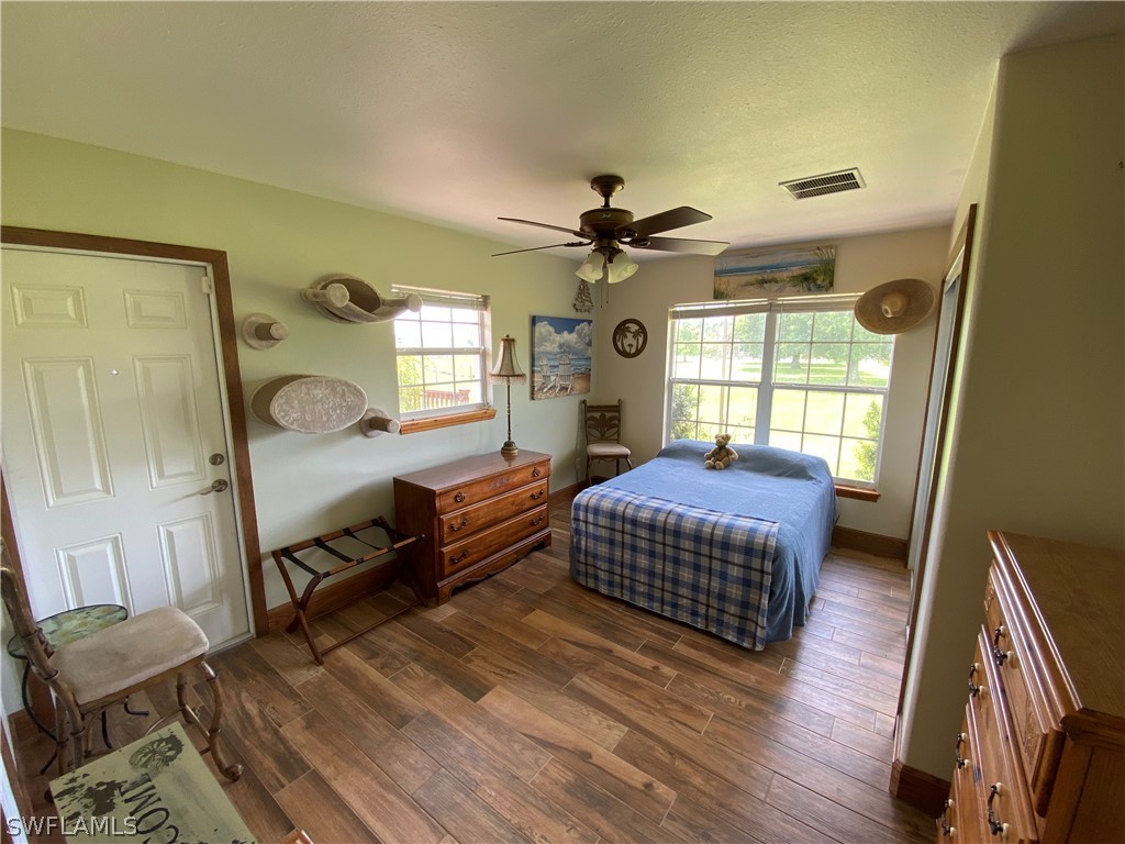 3501 Packinghouse Road Alva, FL 33920 - Photo 12 of 18 a bedroom with a bed and wooden floor
