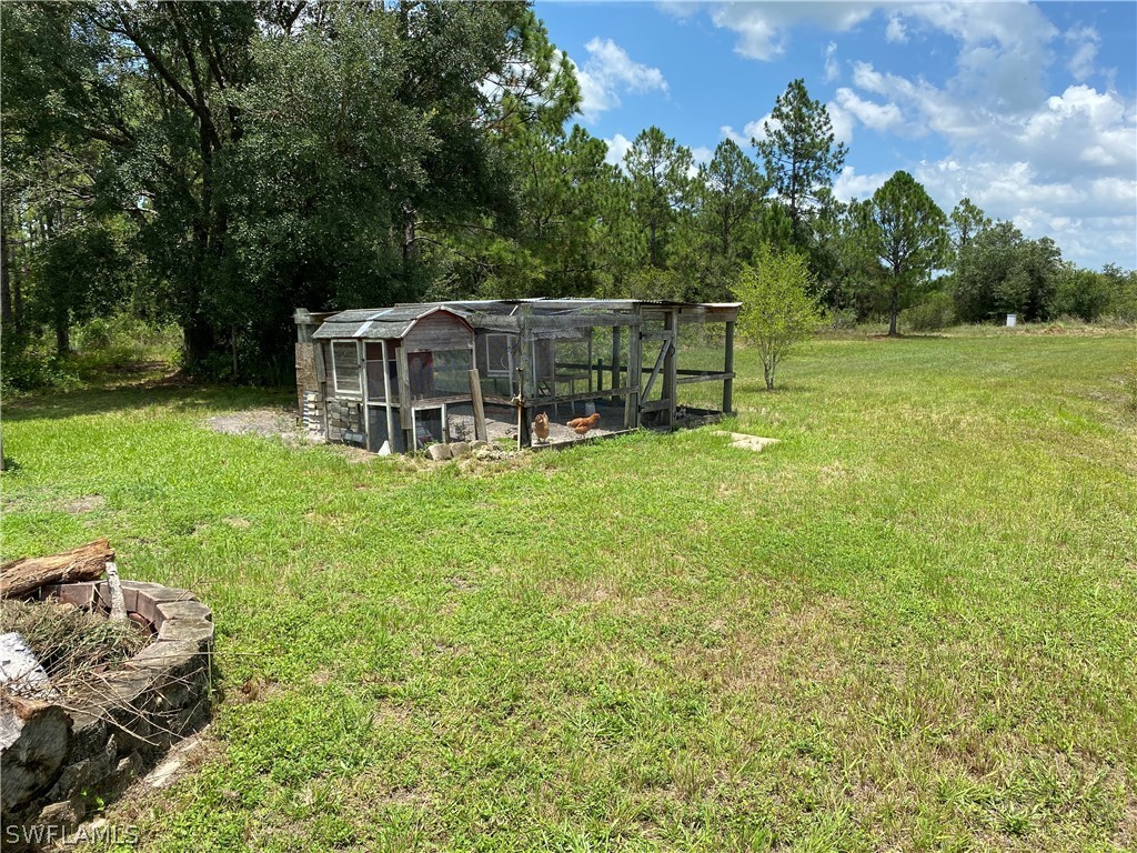 3501 Packinghouse Road Alva, FL 33920 - Photo 16 of 18 a view of a house with backyard porch and sitting area