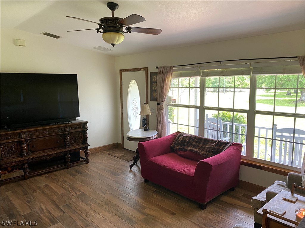 3501 Packinghouse Road Alva, FL 33920 - Photo 3 of 18 a living room with furniture and a flat screen tv