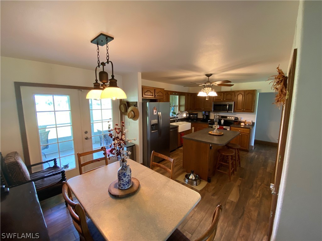 3501 Packinghouse Road Alva, FL 33920 - Photo 7 of 18 a kitchen with a dining table wooden floor and a chandelier