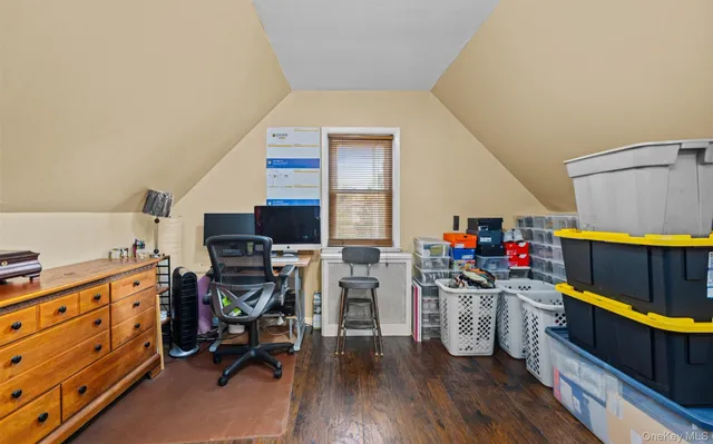 a view of a kitchen with fridge and wooden floor