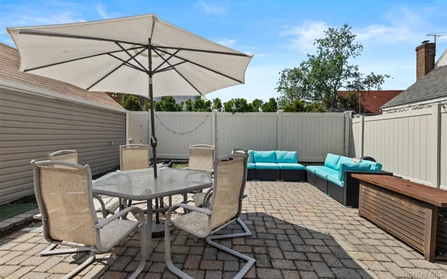 a backyard of a house with table and chairs