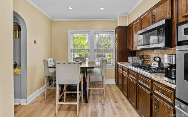 a view of a dining room with furniture a rug and wooden floor